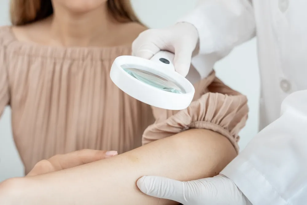 Dermatologist examining a patient's skin